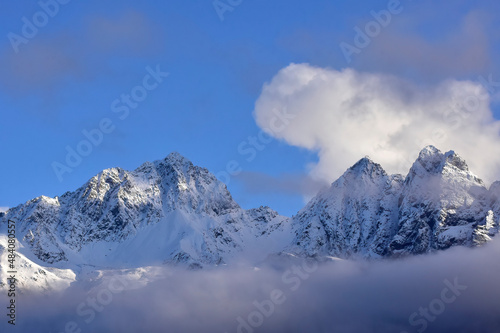 Clouds over snow-covered mountains in winter. © JT Fisherman