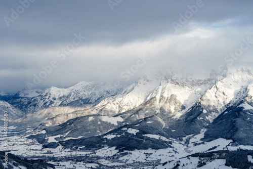 Snow capped mountains under a blanket of clouds and the view of Maria Alm am Steinernen Meer - Hochk  nig region - Salzburg  Austria