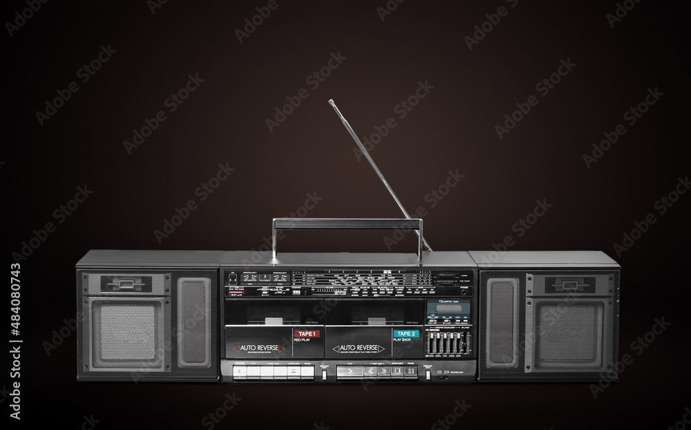 Fototapeta premium Retro vintage portable stereo cassette recorder from 80s on a background.