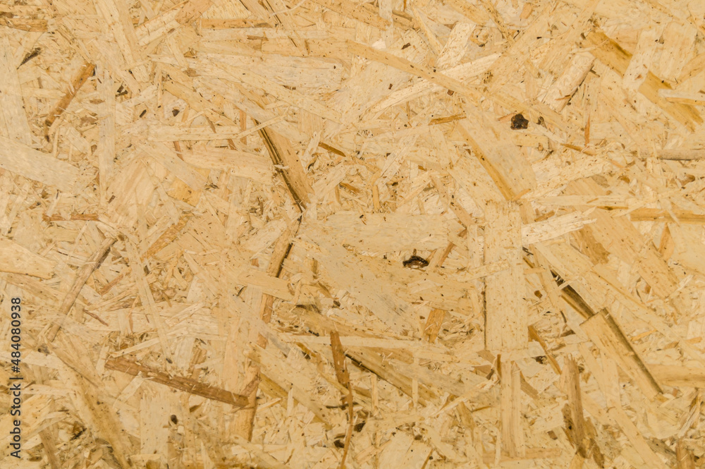 Obraz premium Texture of OSB board. Oriented Strand Boards. Panel of pressed sawdust. Recyclable material. Background