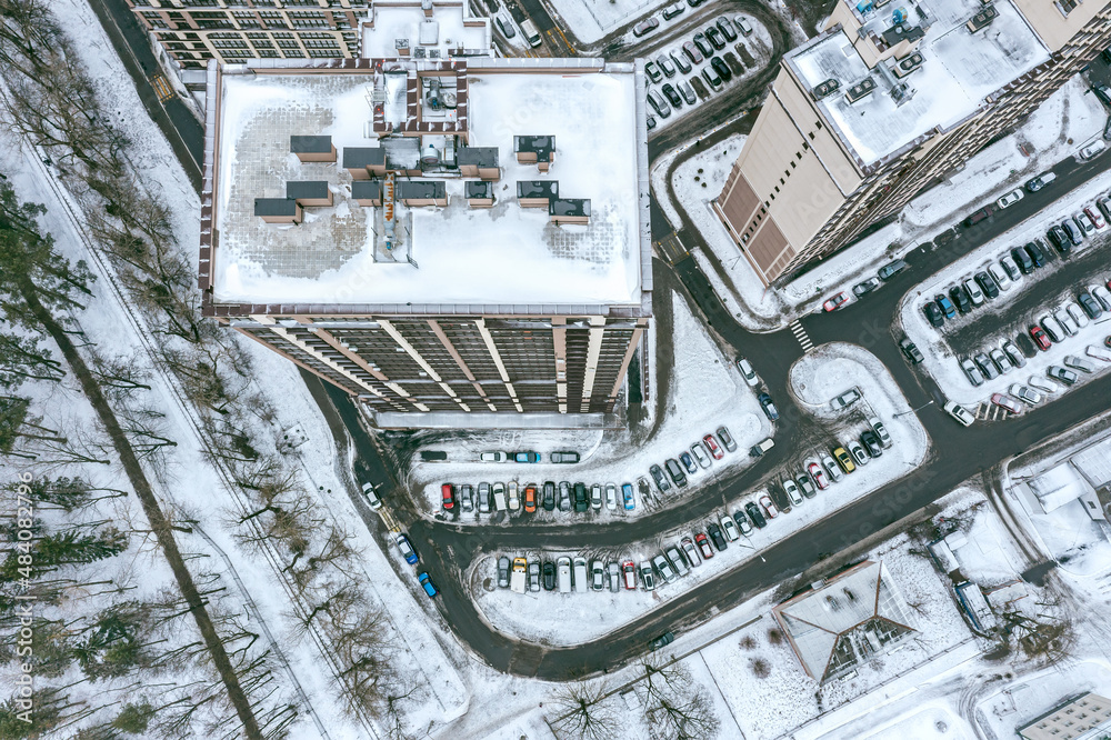 aerial view of multistory apartment buildings in residential area, covered with snow