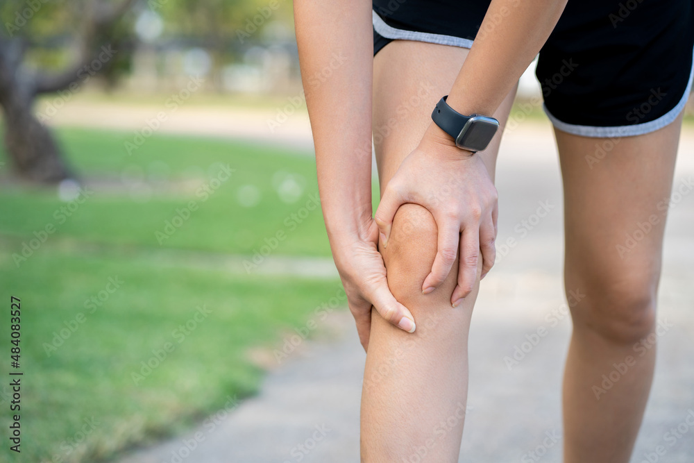 Asian woman runner with running knee injury at park, training too hard Asian woman runner with running knee injury at park, training too hard