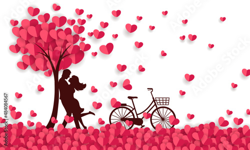 Couple hugging at a field of paper hearts and having a bicycle.