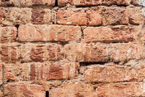 Shabby brick stone wall of aged building