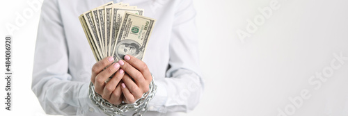фотографія Women hands tied with chain hold one hundred dollar bills