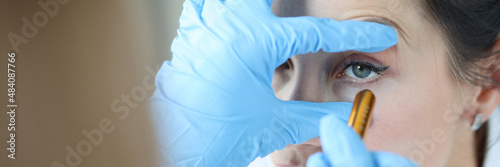 Slika na platnu Doctor shines light into patient eye to check pupil closeup