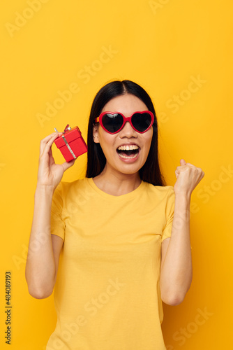 woman wearing sunglasses small gift box isolated background unaltered