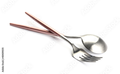 Stainless steel fork and spoon with pink handles on white background