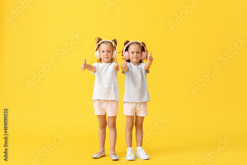 Cute little girls in headph...