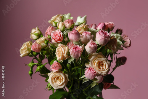 Bouquet of beautiful fresh roses on color background © Pixel-Shot