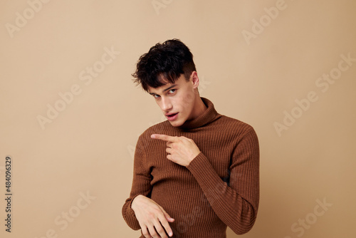 portrait of a young man posing in brown sweater self confidence fashion Lifestyle unaltered © Tatiana