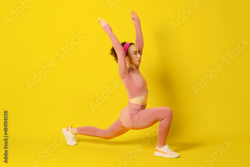 Workout. Athletic Young Woman Doing Exercises Over Yellow Studio Background. Copy Space