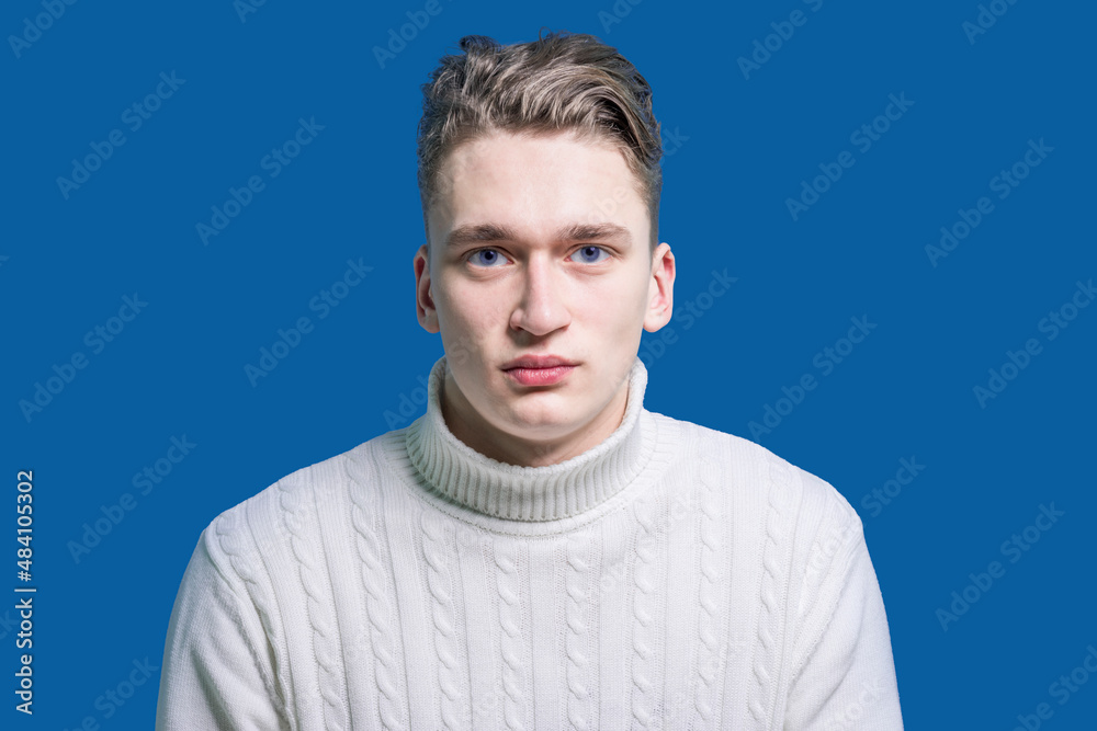 Relationship problems. Calm person. A man in a white sweater looks sadly at the camera. Upset guy. Family troubles. Hard day Relationship problems. Calm person. A man in a white sweater looks sadly at the camera. Upset guy. Family troubles. Hard day