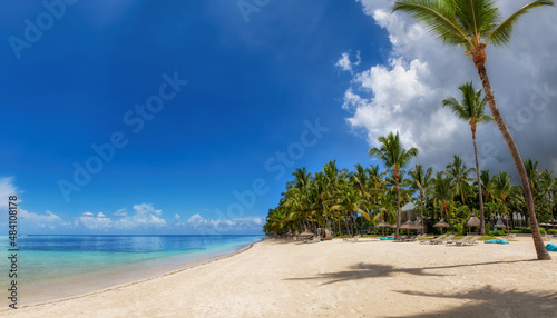 Fototapeta Naklejka Na Ścianę i Meble -  Paradise tropical beach resort. Sunny beach with palms and beach umbrella. Summer vacation and tropical beach concept.