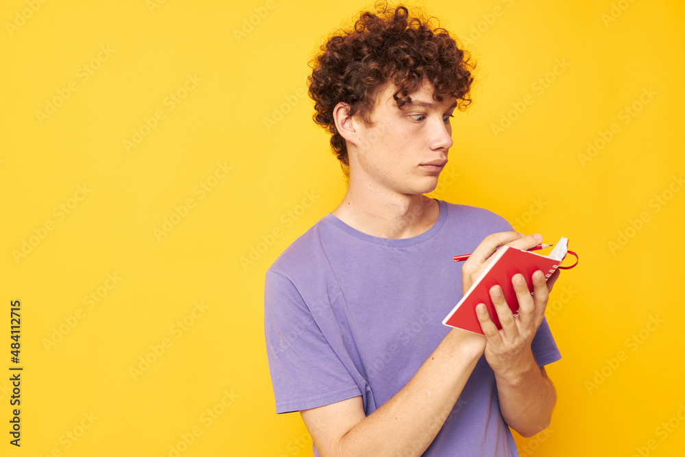 guy with red curly hair notepad with pen learning emotions yellow background unaltered guy with red curly hair notepad with pen learning emotions yellow background unaltered