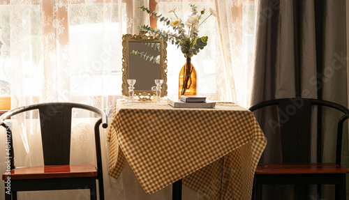 Tables, chairs, lamps, flowers, arranged in the corner of the room perfectly and beautifully.