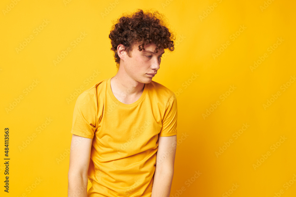 cute red-haired guy wearing stylish yellow t-shirt posing isolated background unaltered cute red-haired guy wearing stylish yellow t-shirt posing isolated background unaltered