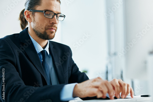 male manager at his desk working in front of a computer