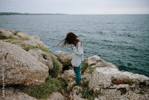 portrait of a woman beach tourism cloudy weather stone coast Relaxation concept