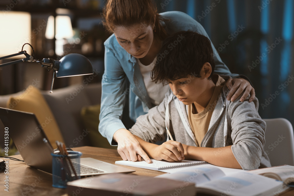 Tutor helping a student with his homework Tutor helping a student with his homework