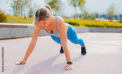 Fit happy confident woman in sportswear doing stretching by throwing leg on concrete parapet