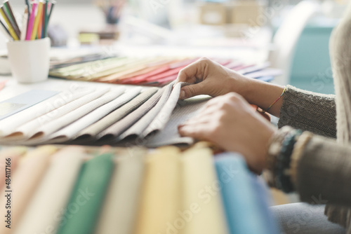 Fotografija Professional decorator picking fabric swatches