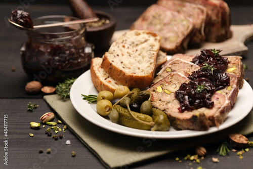 Fotografi Sliced Traditional French terrine covered with bacon on dark wooden background