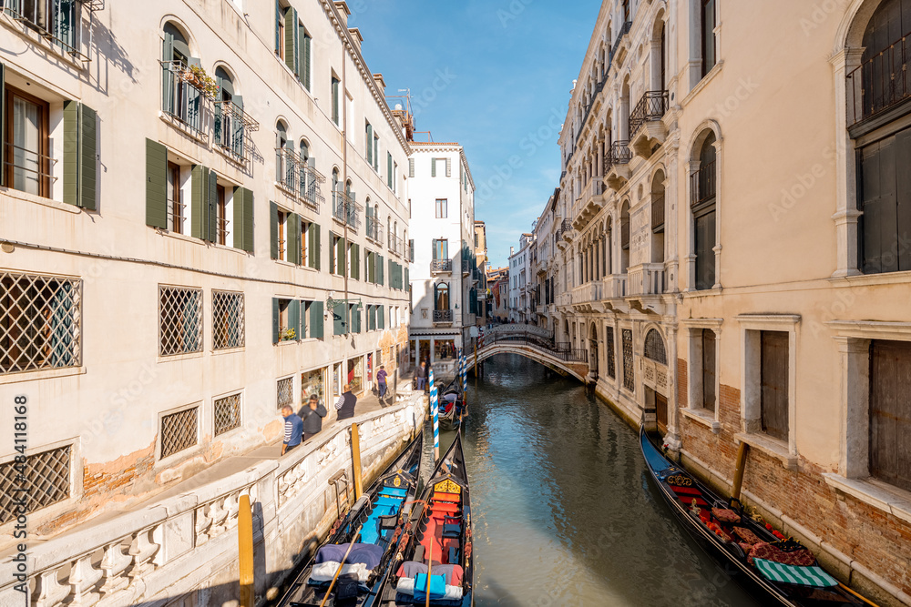 Cityscape of the beautiful narrow water channels on a sunny day in Venice. Traveling Italy concept