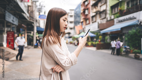 Young adult asian woman using mobile phone for social media application.