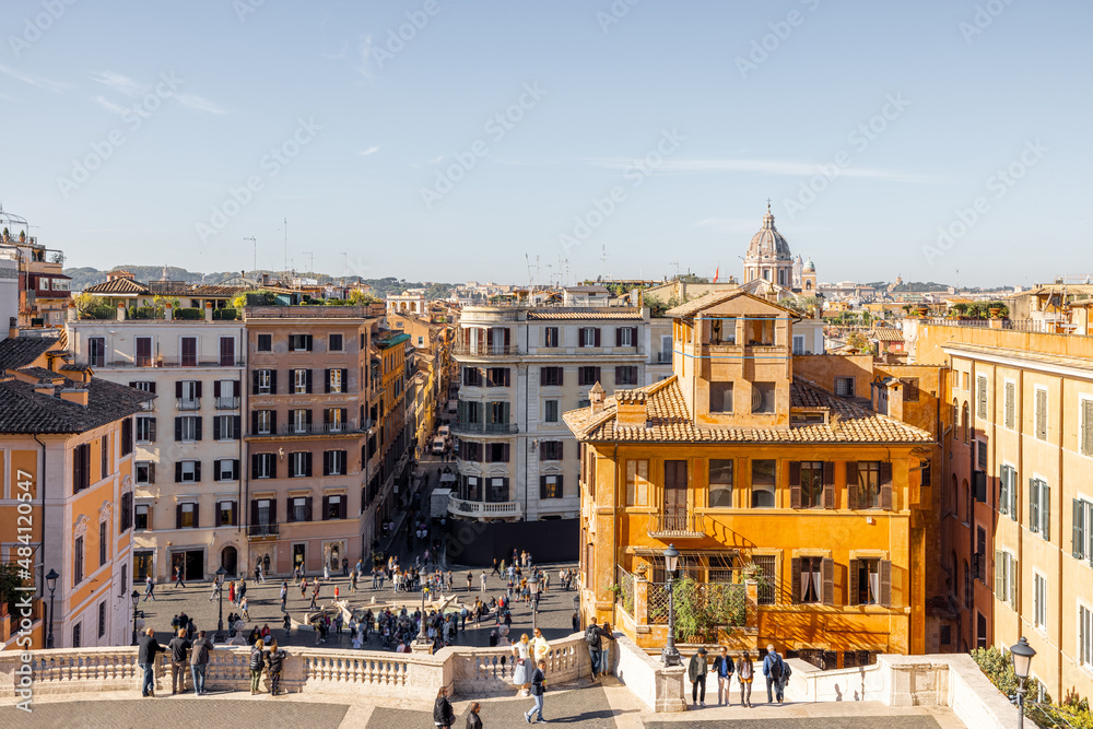 Cityscape view on the old town from the top of famous Spanish stairs in Rome on a sunny day. Traveling Italian landmarks concept. Architecture and buildings in Rome
