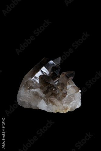 Smoky quartz, a brownish grey gemstone on black background.