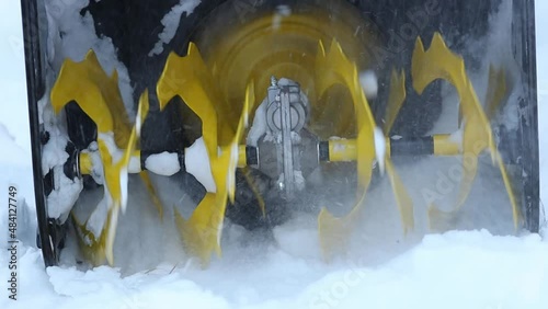 Cleaning the territory with the help of a snowblower during a snowfall. Close up.