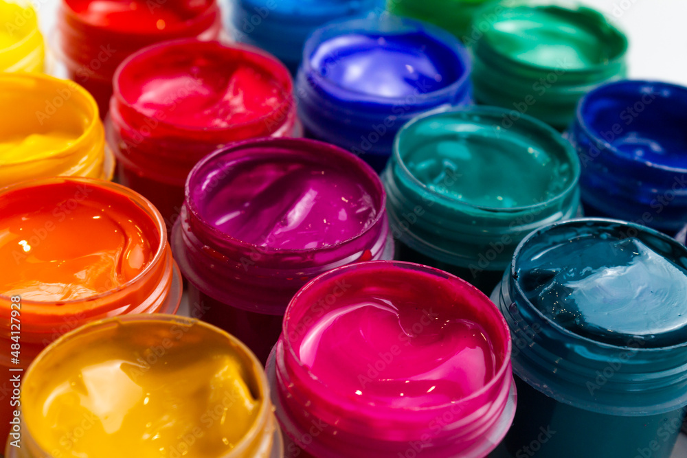 Selective focus open jars with gouache of different colors close-up. Hobby - painting Selective focus open jars with gouache of different colors close-up. Hobby - painting