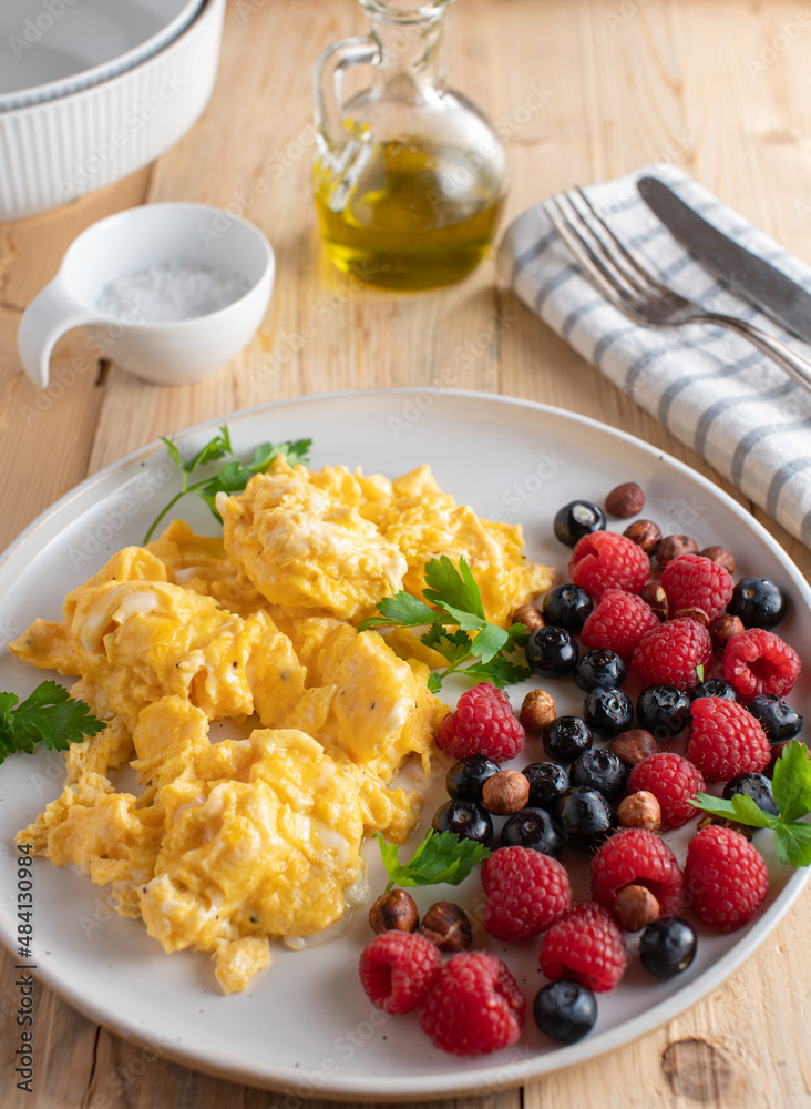 Ketogenic breakfast plate with scrambled eggs, fresh berries and hazelnuts Ketogenic breakfast plate with scrambled eggs, fresh berries and hazelnuts
