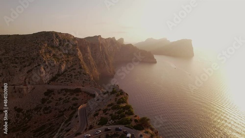 Cape Formentor Lighthouse and cliffs at sunset photo