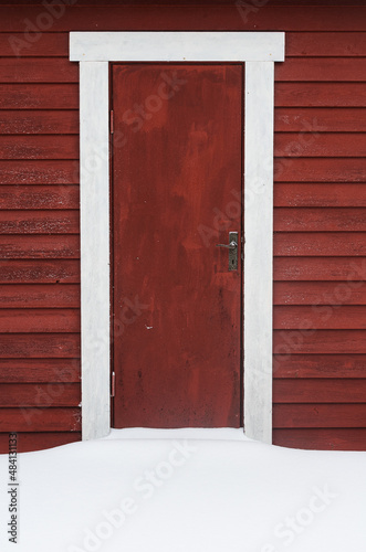 Snow in front of red door