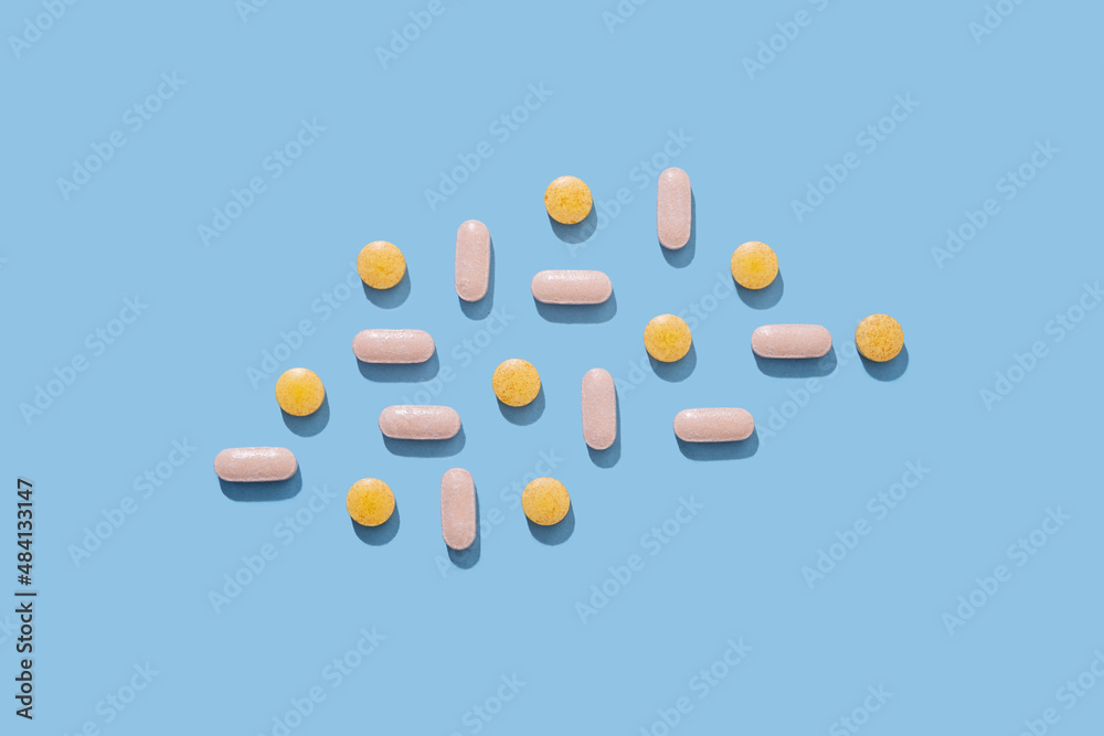 Medical pills on blue background. 
Nutritional supplements and vitamins concept
