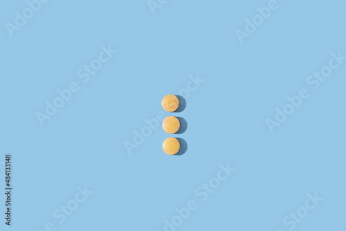 Medical pills on blue background. 
Nutritional supplements and vitamins concept