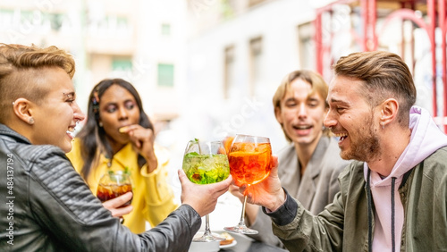 Diverse friends toasting with non alcoholic colorful beverage, lgbt people having fun after gay pride parade