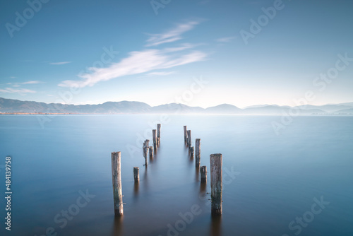 Wooden pier remains at sunrise. Massaciuccoli lake. Torre del Lago Puccini, Versilia, Tuscany, Italy photo