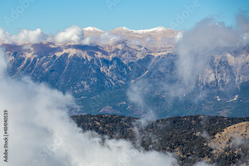 White fluffy clouds over scenic mountains. Scenic cloudy landscape of Turkey