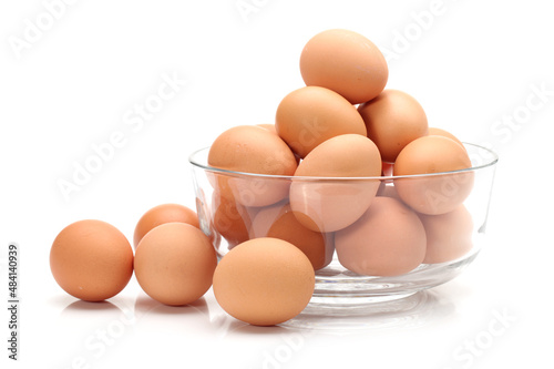 eggs in a glass bowl on white background .
