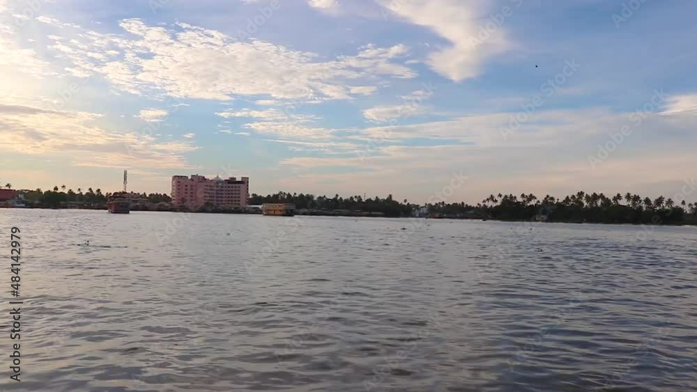 sea backwater with many traditional houseboats running and amazing sky at morning sea backwater with many traditional houseboats running and amazing sky at morning