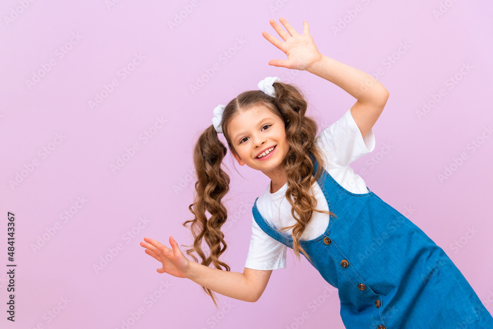 The child looks out from around the corner and rejoices, the child waves his hands in a good mood. The child looks out from around the corner and rejoices, the child waves his hands in a good mood.