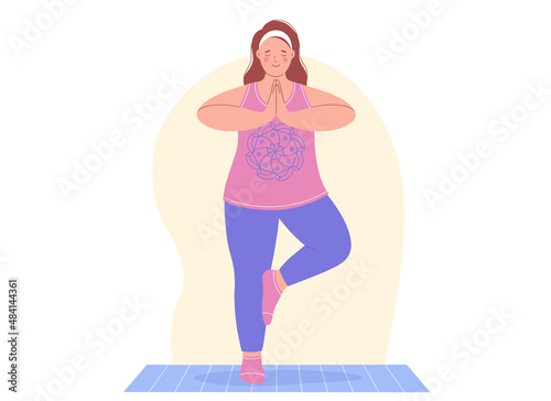 Aerobic, fitness and yoga classes. Plump young woman is doing yoga exercise on a mat. Concept of healthy lifestyle and sports.