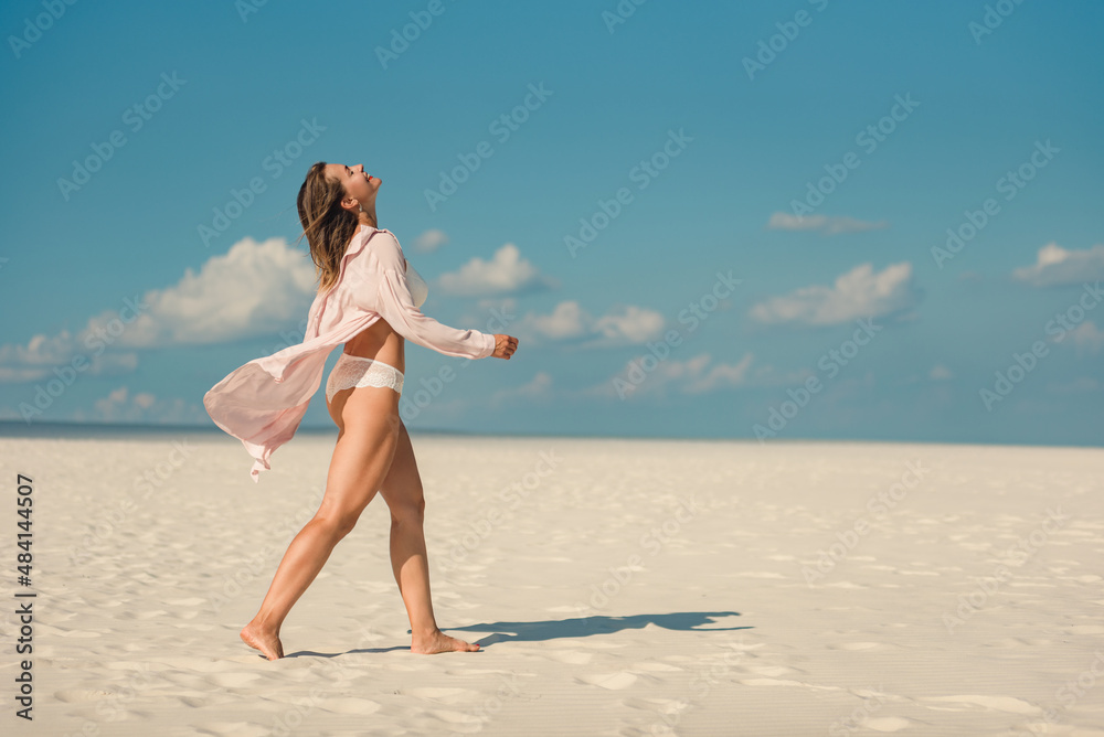 Beautiful happy mature woman enjoying sunny day on beach Beautiful happy mature woman enjoying sunny day on beach