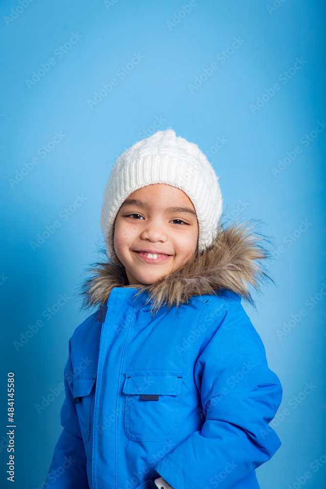 portrait on blue background of young Asian girl with smile looking at camera portrait on blue background of young Asian girl with smile looking at camera