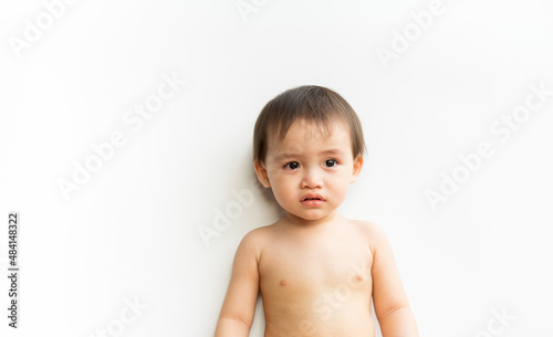 Portrait of baby boy standing crying on white isolated background. Cute little son child is crying. Support protection of empathy and consoling concept, Family relationships concept.