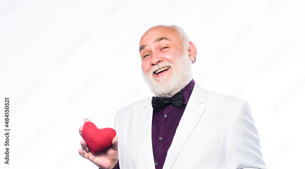 True gentleman. Well groomed handsome bearded man wear tuxedo. Senior gentleman romantic soul. Man hold heart symbol of love. Romance and dating. Dating services for elderly people. Gentleman concept True gentleman. Well groomed handsome bearded man wear tuxedo. Senior gentleman romantic soul. Man hold heart symbol of love. Romance and dating. Dating services for elderly people. Gentleman concept