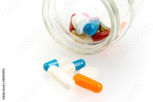 Set of different colorful pills and capsules isolated on white background.